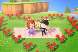 Screenshot of two animated figures with a bed of roses for a story about dating through Animal Crossing during coronavirus.