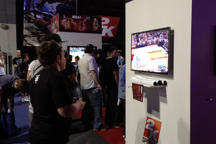 Gamer tries a basketball game at the EB Expo
