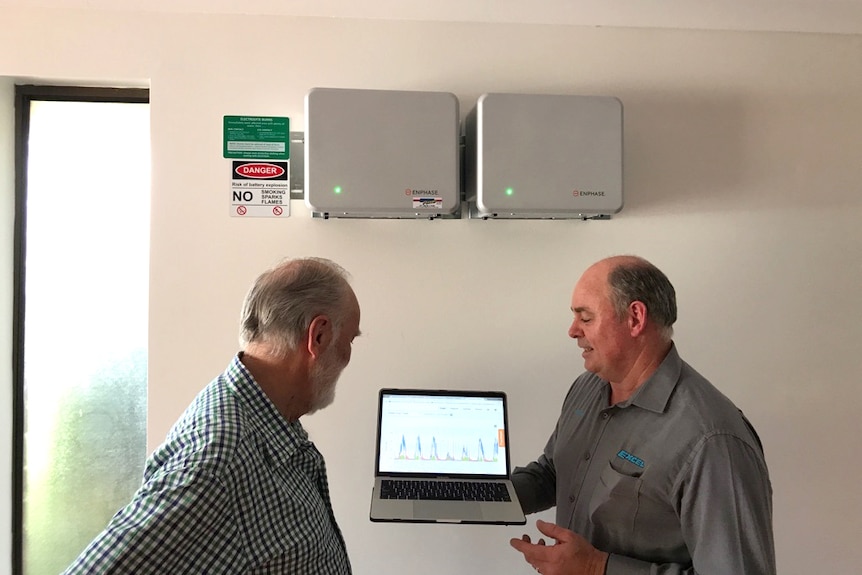Will Braithwaite (left) with electrician Michael Reiken who installed a $6000 hybrid system.