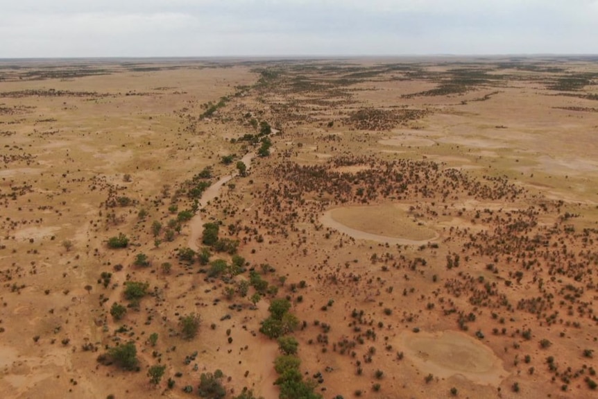 An aerial view of a dry, arid landscape stretching for miles.