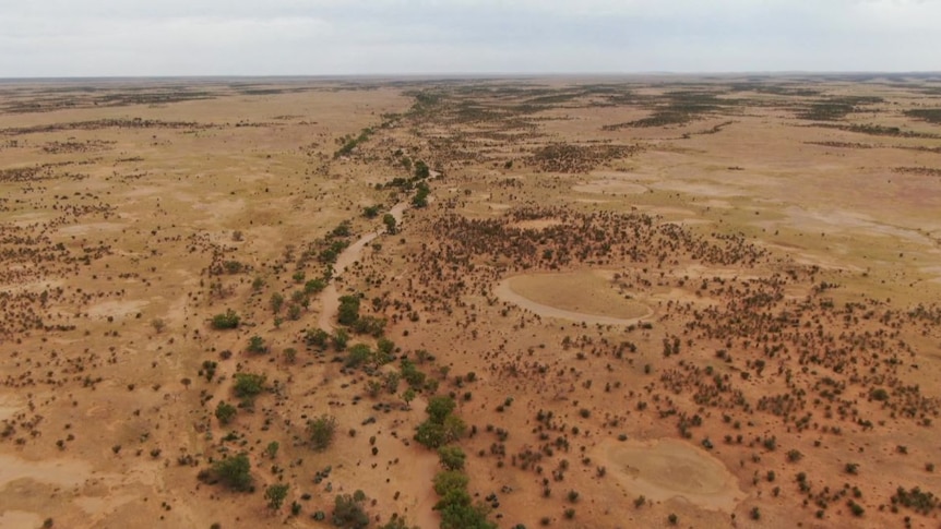 An aerial view of a dry, arid landscape stretching for miles.