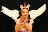 Young girl with pantomime wings