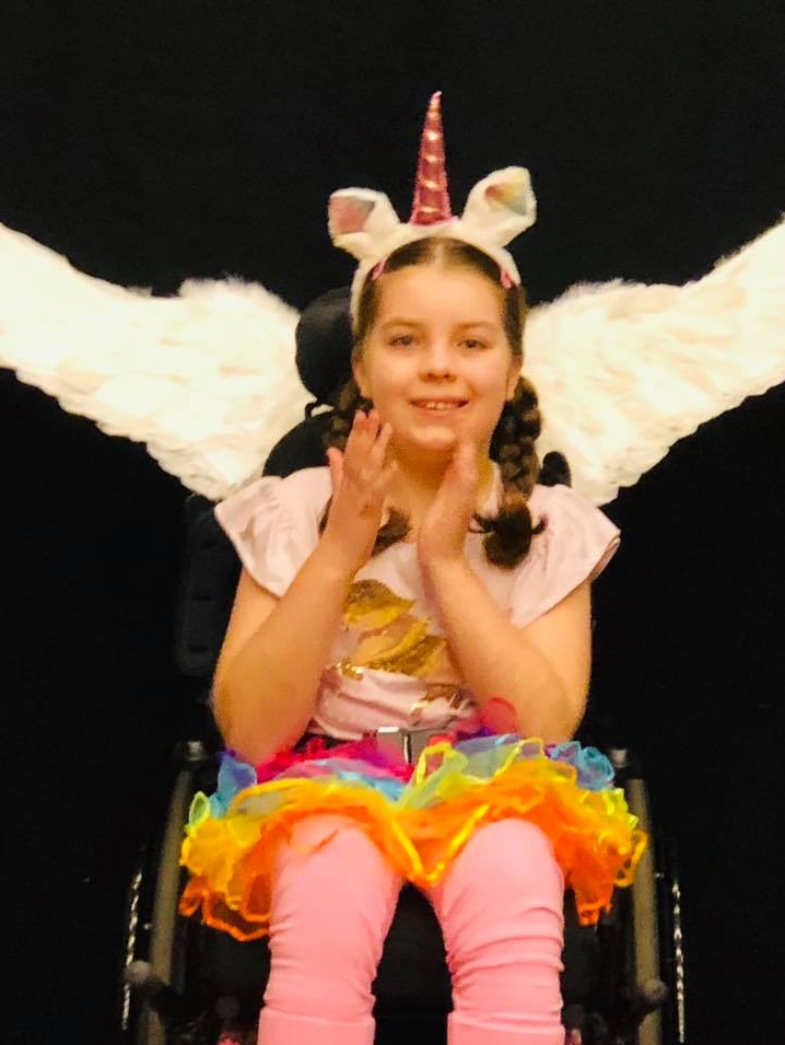 Young girl with pantomime wings