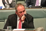 Former Nationals leader Barnaby Joyce during Question Time, with his eyes closed and resting on his hand.