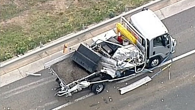 The damaged truck sitting in the emergency lane of the Western Ring Road.