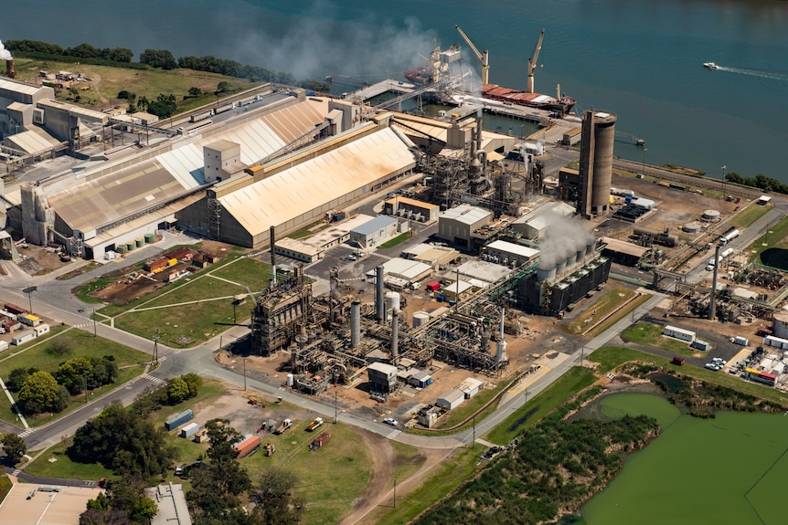 An aerial shot of an industrial area fronting onto water.