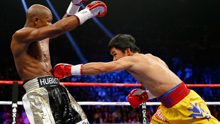 Manny Pacquiao throws a left at Floyd Mayweather during their title bout in Las Vegas in May 2015.