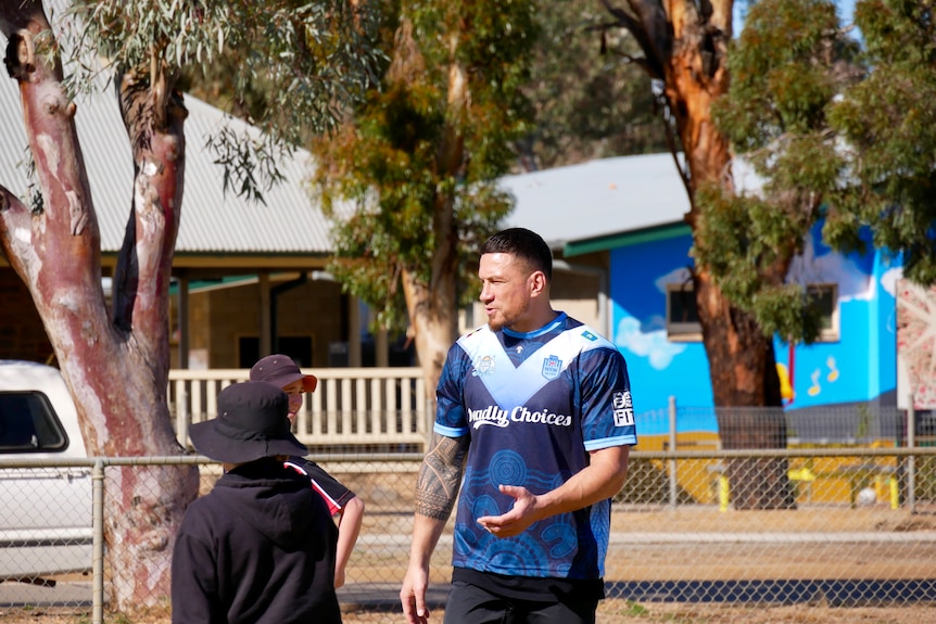 Sonny Bill Williams teaching kids how to play touch football at the Burke Ward School in Broken Hill. 