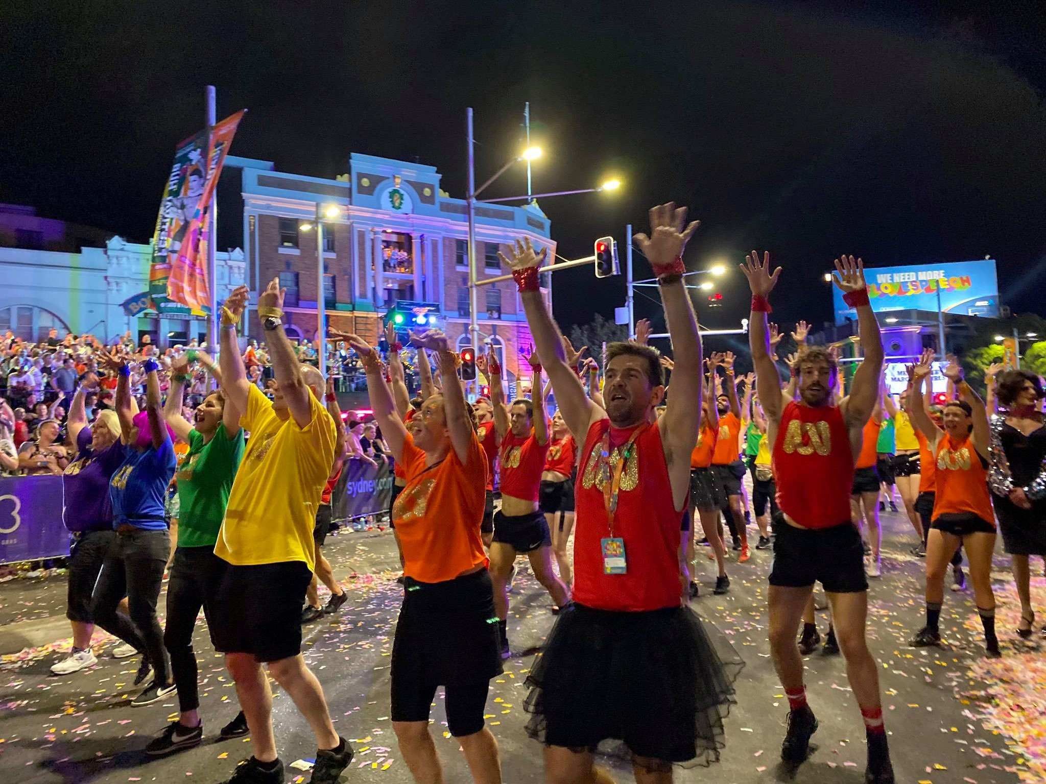ABC staff marching in colourful T-shirts at the Sydney Mardi Gras