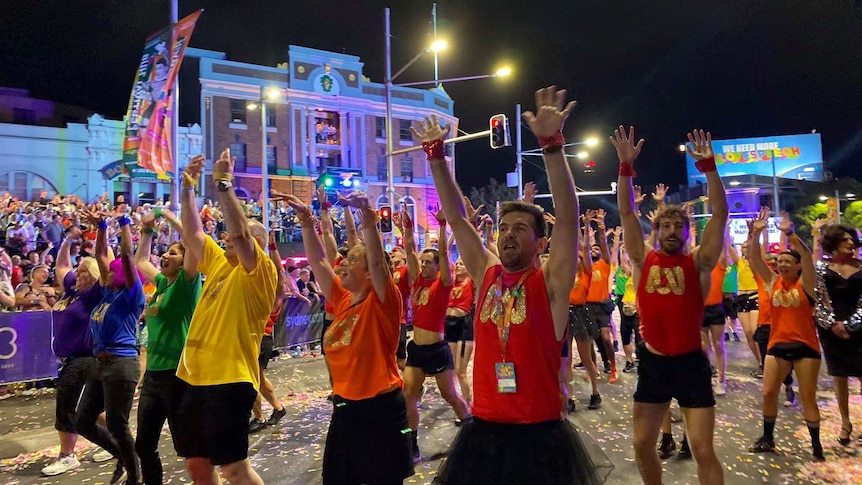 ABC staff marching in colourful T-shirts at the Sydney Mardi Gras