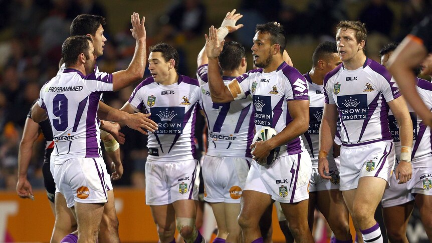 Melbourne Storm players celebrate Will Chambers' try against Wests Tigers