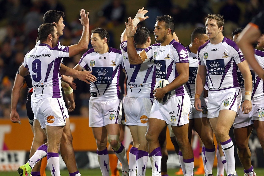 Melbourne Storm players celebrate Will Chambers' try against Wests Tigers
