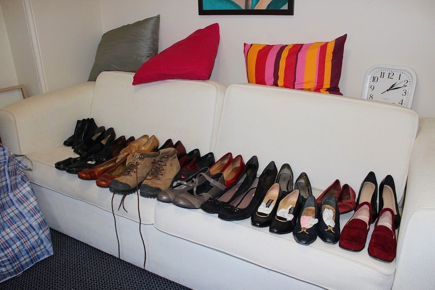 Shoes placed in a line on a couch