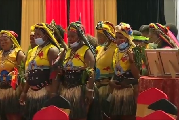 Traditional dancers wear face masks to prevent the spread of COVID-19