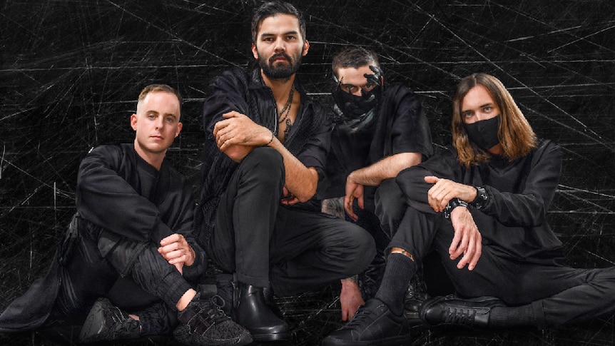 Image of Northlane, all dressed in black, two members with face masks