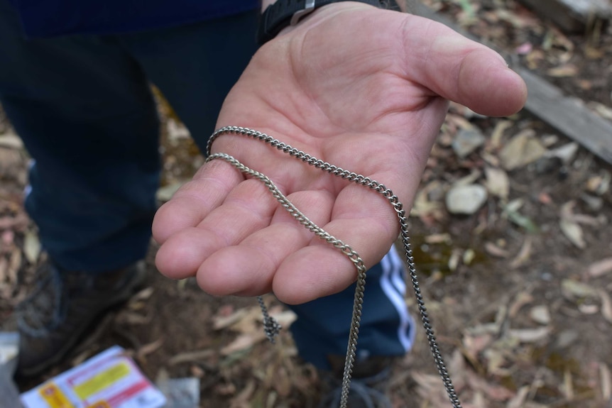 Daryl Floyd holds a necklace