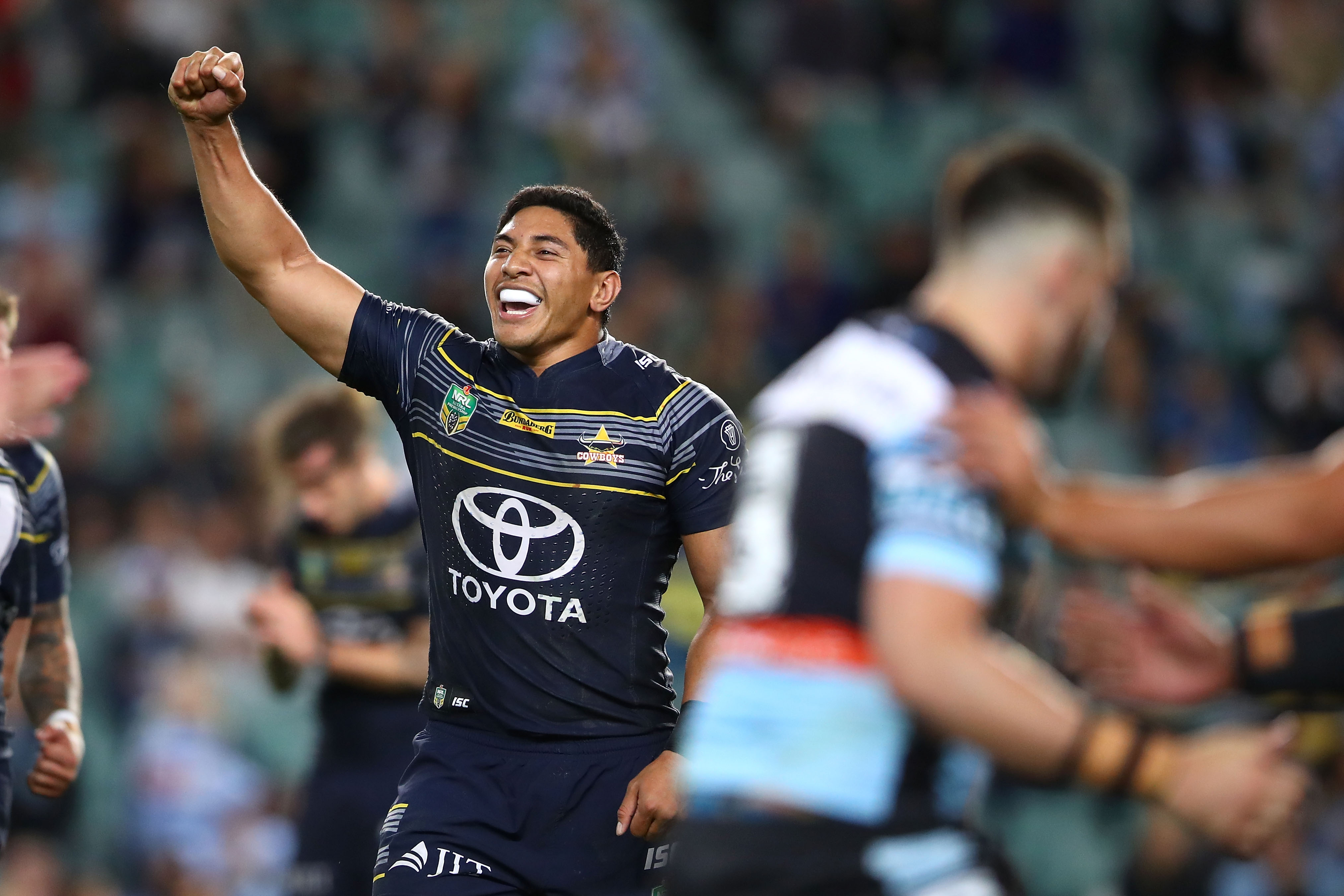 Jason runs the ball during a rugby league match.