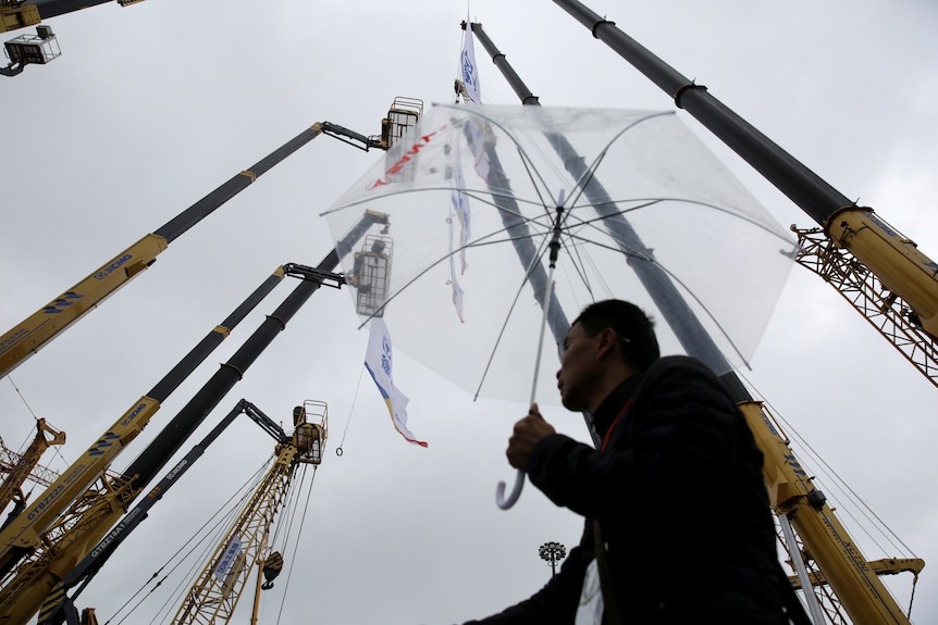 A man looking at a construction site.