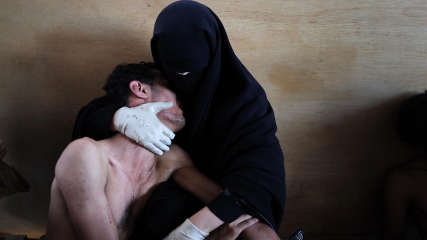 A woman holds her wounded son in her arms during protests against president Saleh, Sanaa, Yemen.