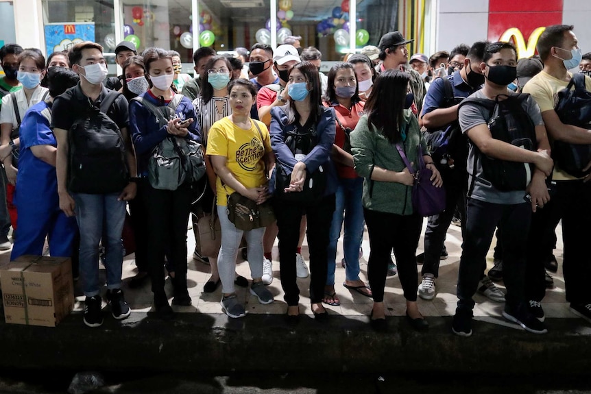 A group of people in Manila in face masks