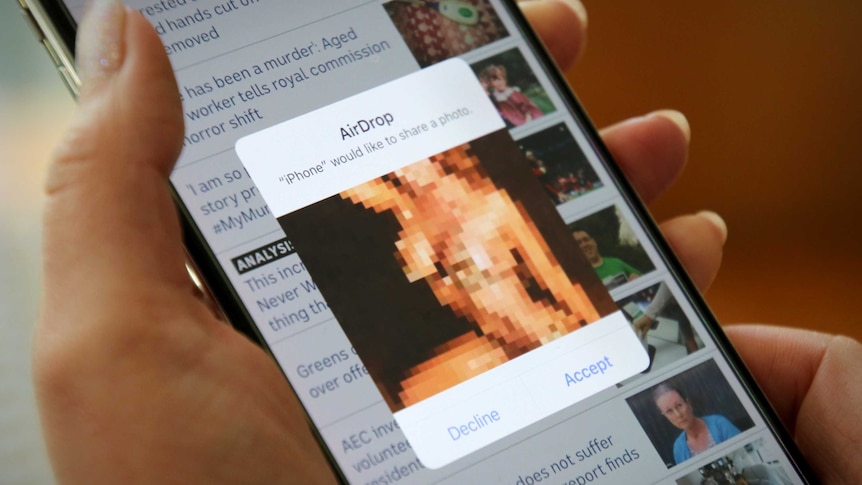 Woman being sent an AirDrop file on iPhone