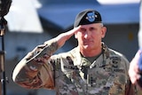 General Robert Brown salutes.