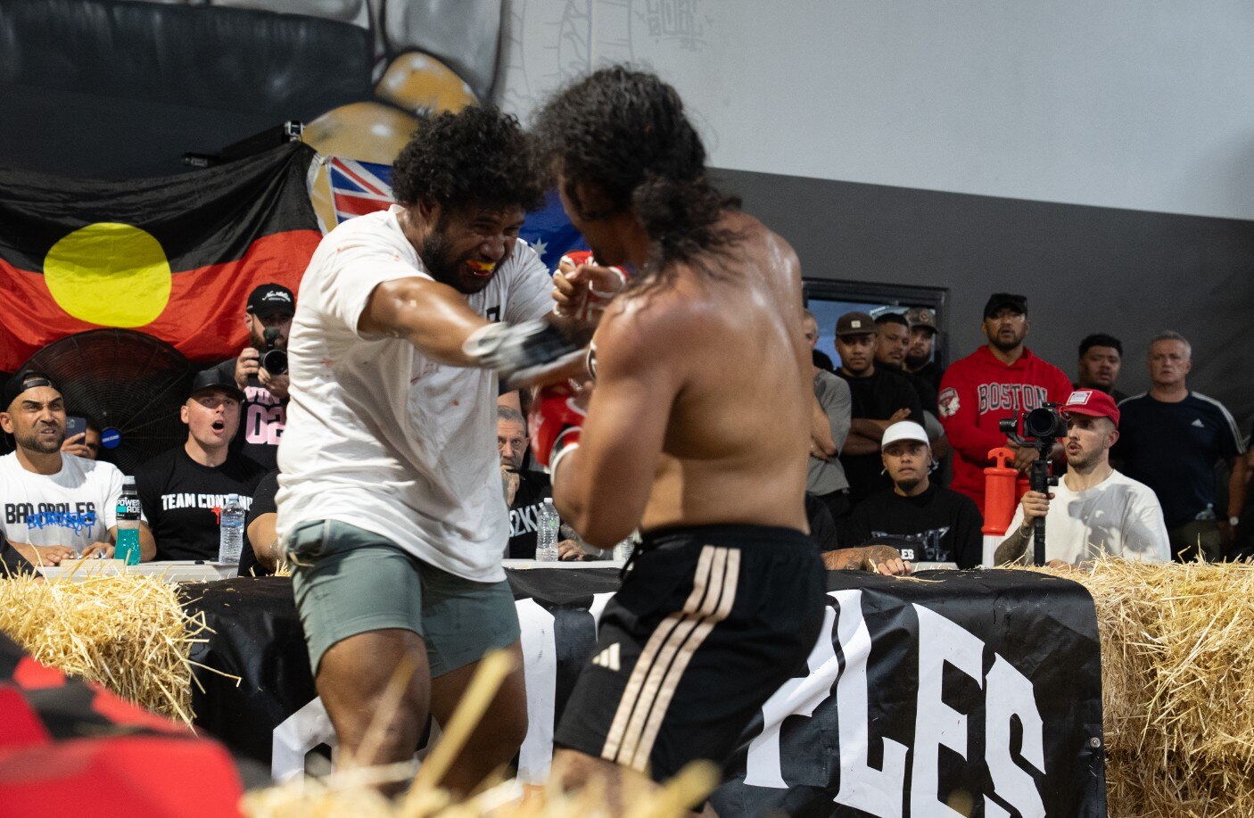 Two men fight in a ring.