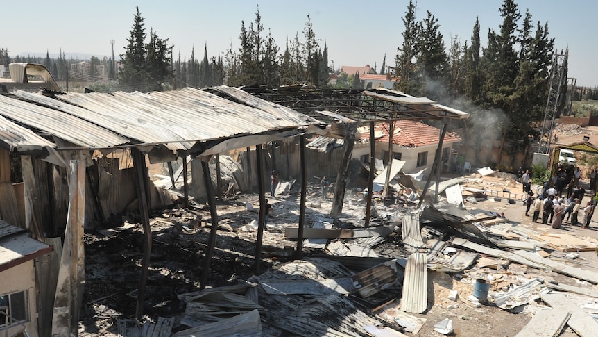 Damage at the site of an attack on the pro-government Al-Ikhbariya satellite television channel's offices outside Damascus.