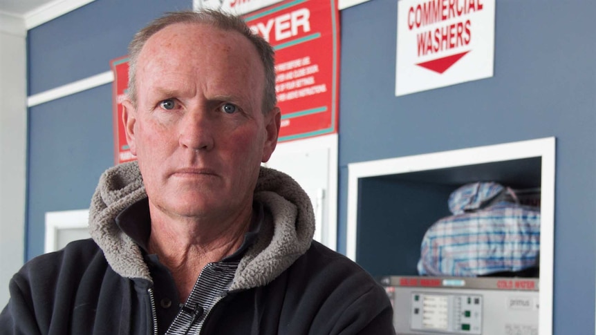 Chris Brady stands in his bust laundromat in Stanthorpe