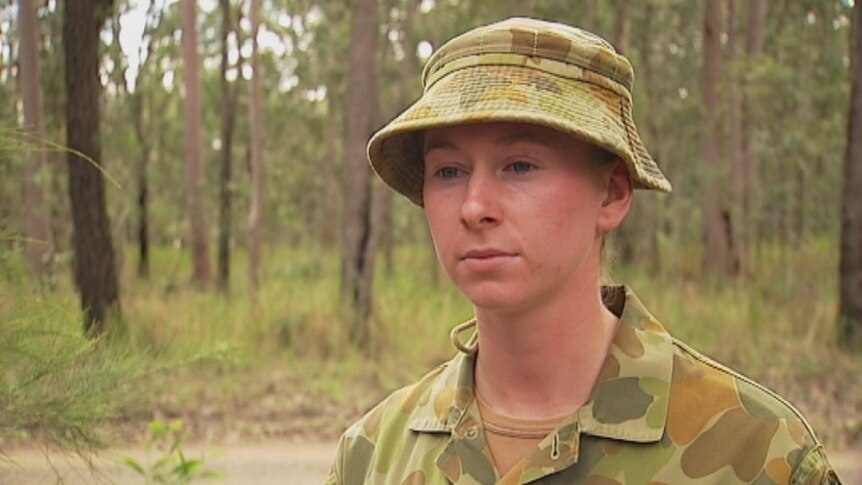 Woman soldier in fatigues in the bush