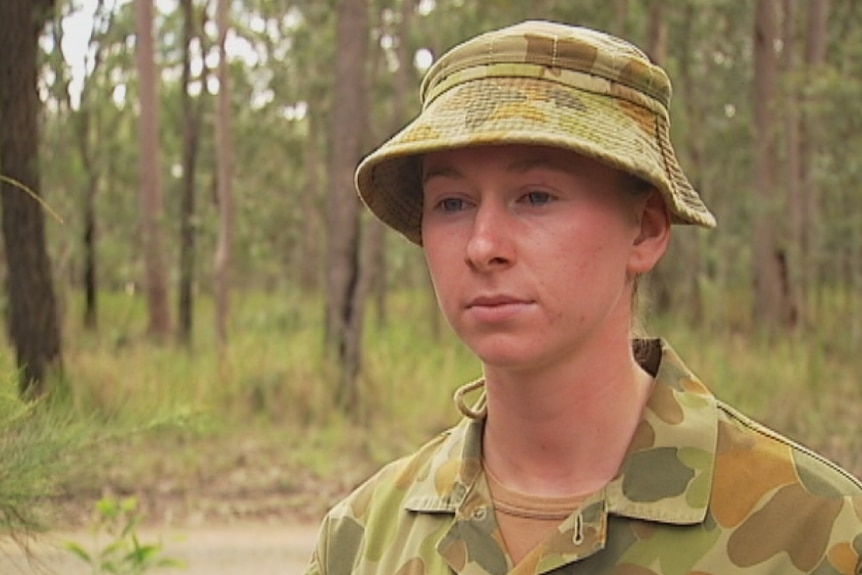 Woman soldier in fatigues in the bush