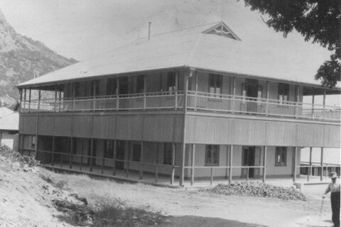 A black and white picture of a old two-storey house from the early 1900s