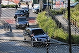 The presidential motorcade leaving Marine One's landing site in Herston.