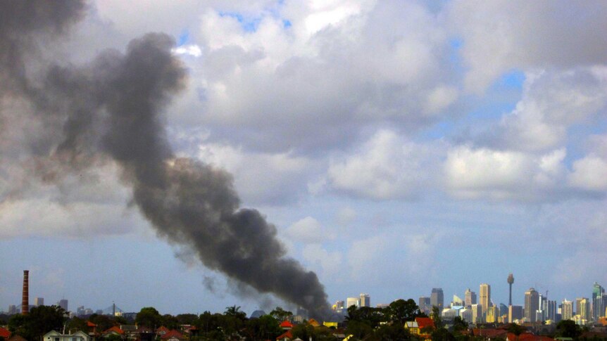 Smoke rises from a furniture factory fire at Marrickville.