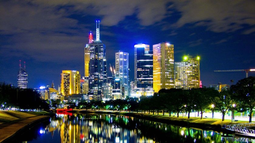 The Melbourne skyline is reflected on the Yarra River on the night