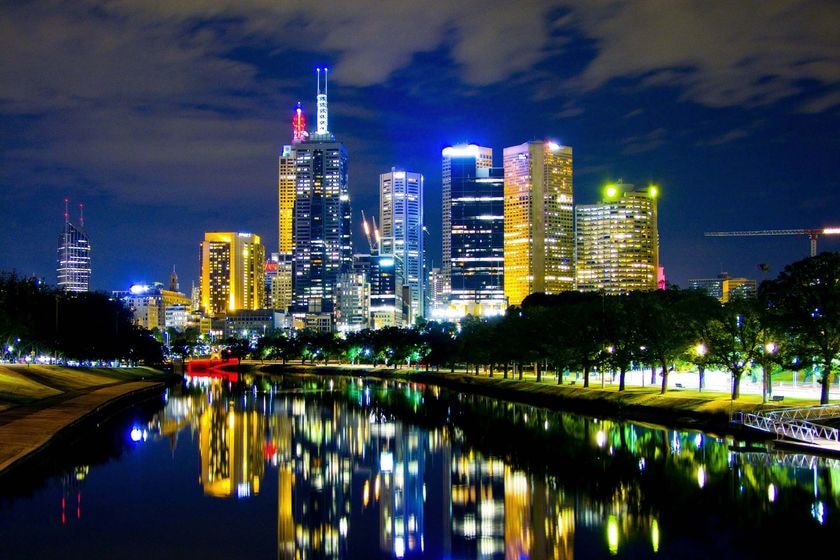 The Melbourne skyline is reflected on the Yarra River on the night (ABC News: Lloyd Young)