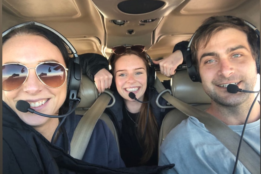 Three people inside a small plane