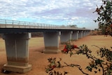 The dry sandy bed of the Gascoyne River can be seen under a traffic bridge.