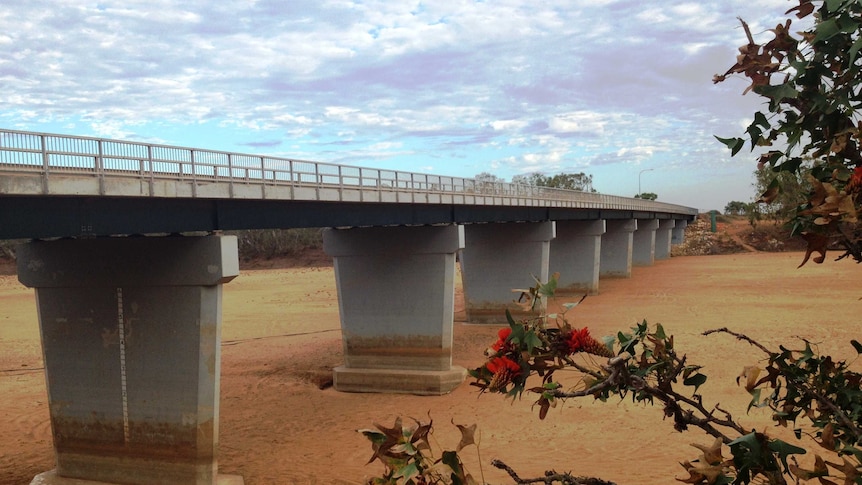 The dry sandy bed of the Gascoyne River can be seen under a traffic bridge.