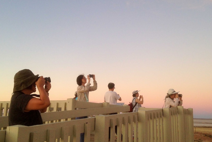 Chinese tourists line up to take photos of the sunset at Lake Tyrrell, Sea Lake.