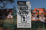 a sign saying just vote one in election font