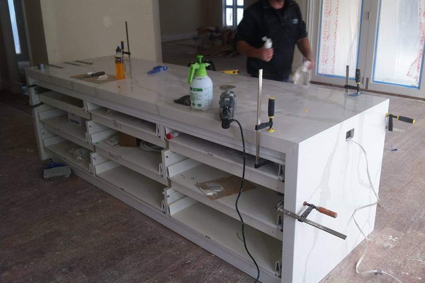 Stone kitchen bench covered in tools