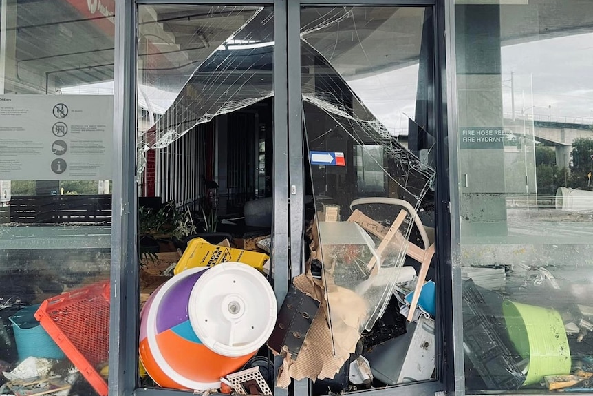 Shop front with goods smashed into doors