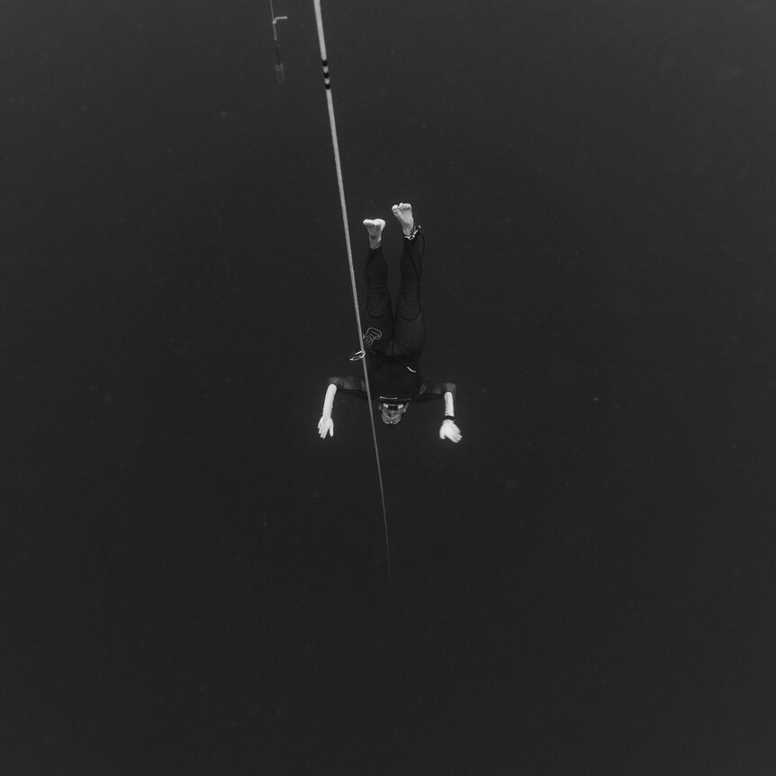 man diving underwater