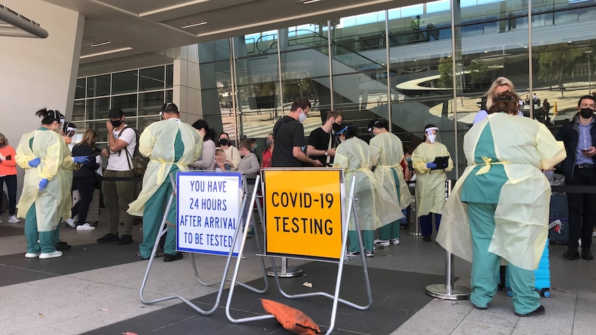 A crowd of people line up for covid testing