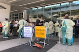 A crowd of people line up for covid testing