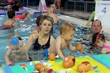 Olympian Regan Harrison (right) with his daughter Leilani and other participants in the World's Largest Swimming Lesson.