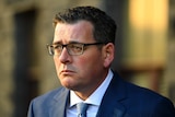Victorian Premier Daniel Andrews looks slightly concerned as he talks to media outside State Parliament.