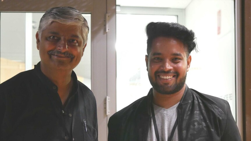 Two Indian men smile for the camera