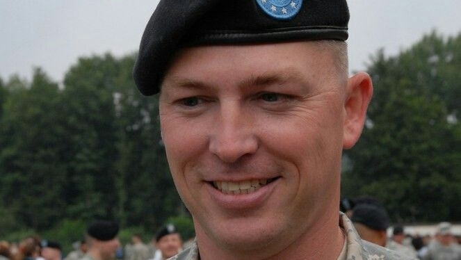 Bryan Denny wearing a military beret and uniform.